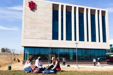 Students sit in front of the new medical science building in Bloomington.