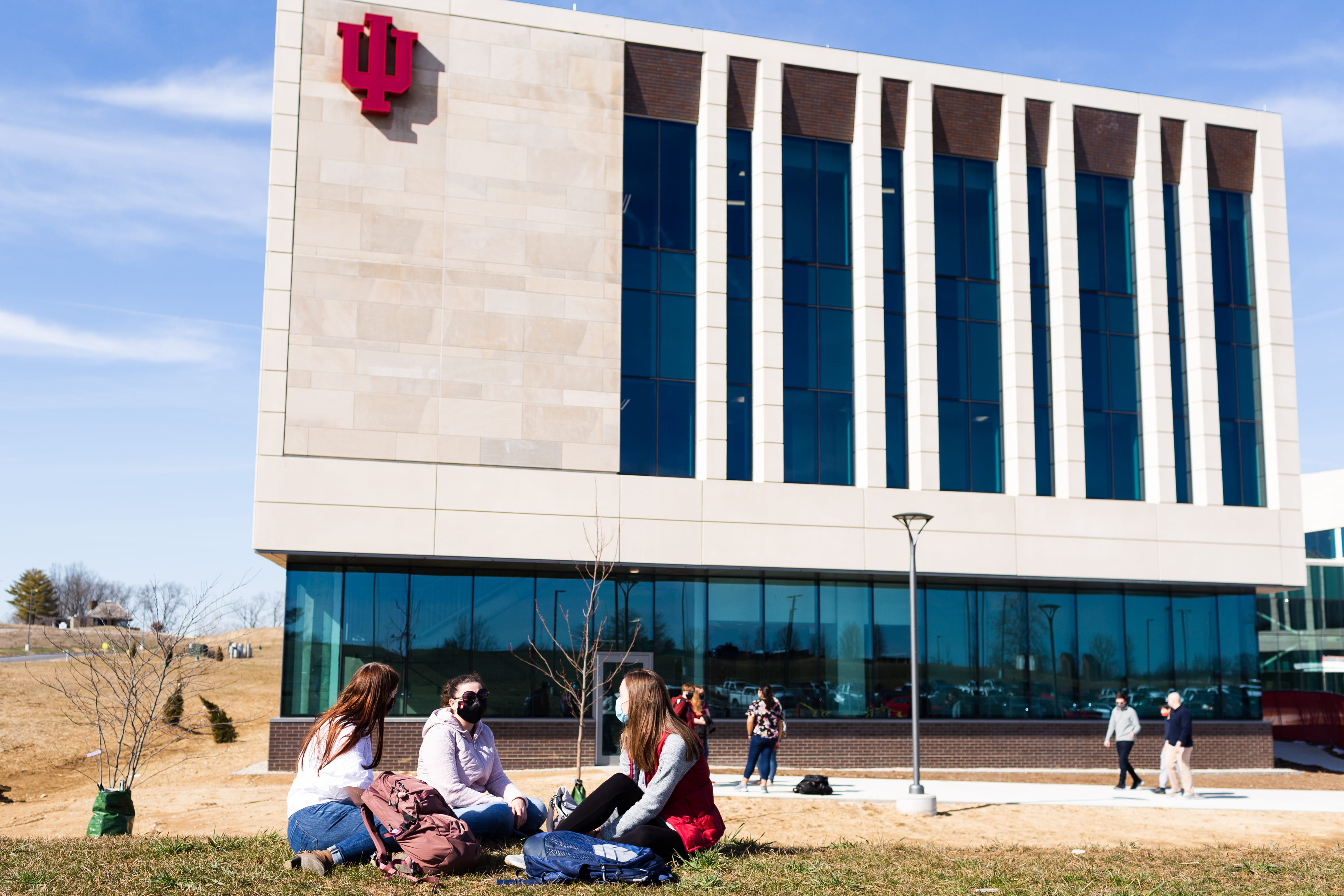 Students sit in front of the new medical science building in Bloomington.