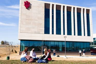 Students sit in front of the new medical science building in Bloomington.