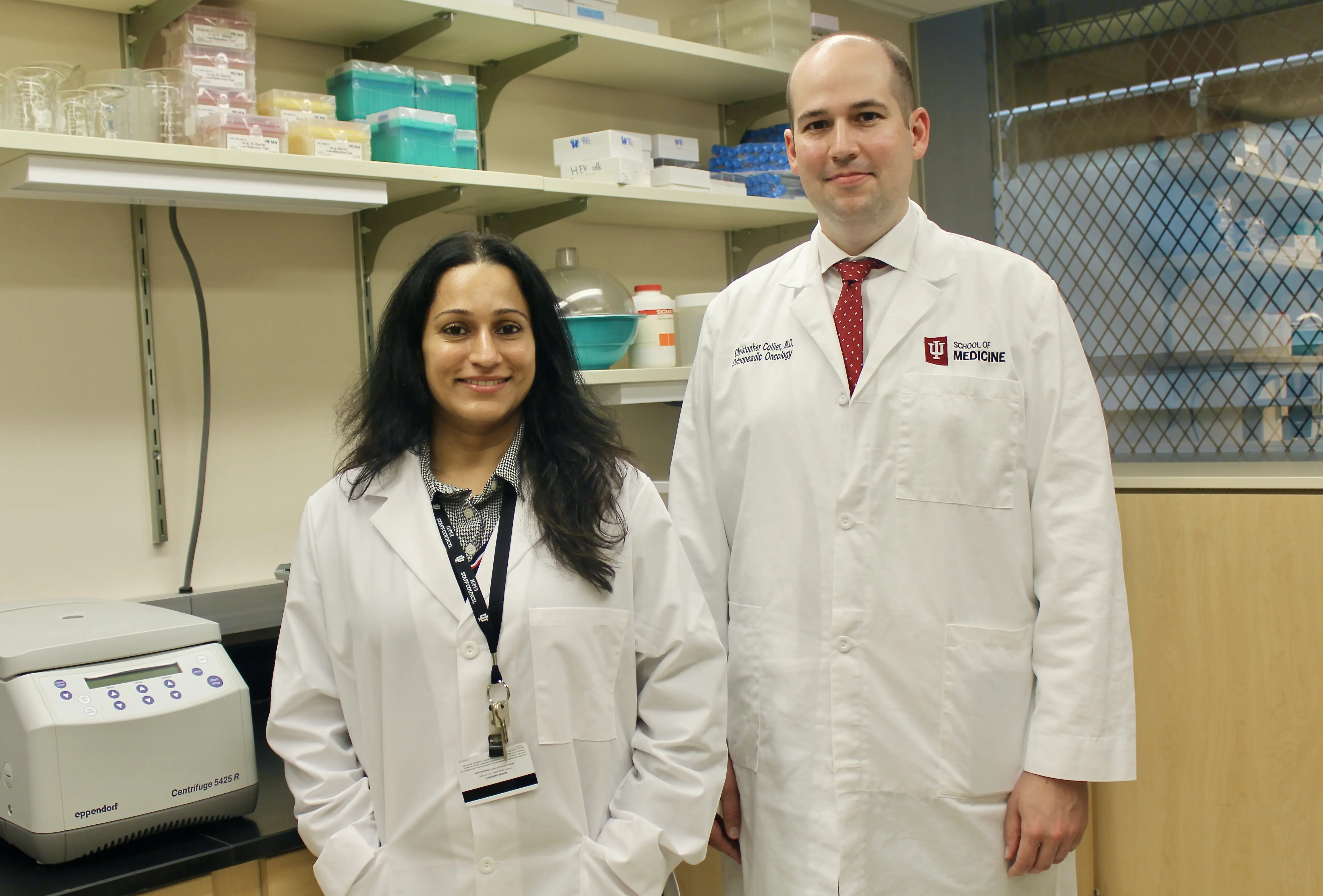 Research Analyst Anuradha Valiya Kambrath and Dr. Christopher Collier stand in the Collier lab.  