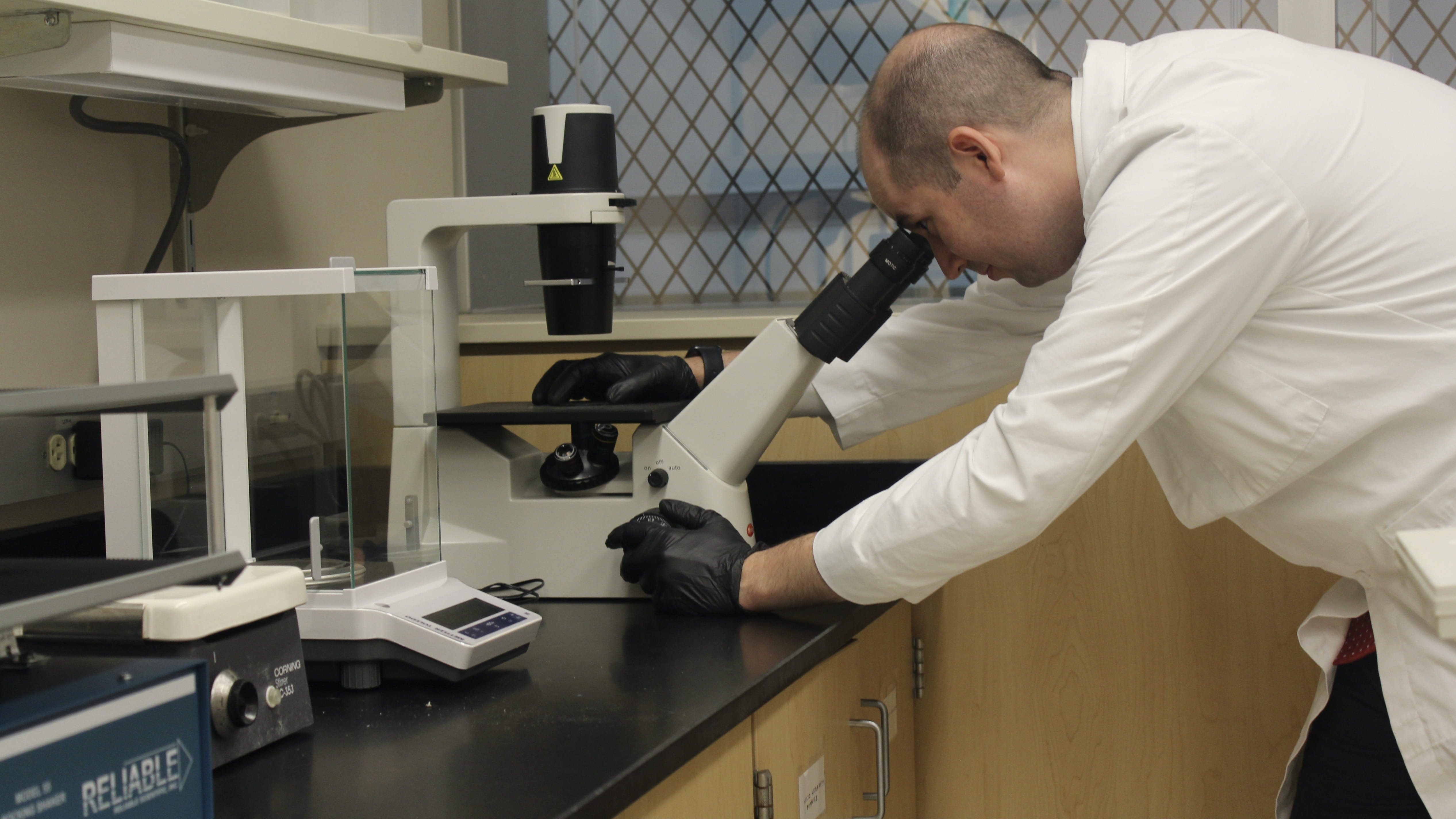 Christopher Collier, MD, works in his lab