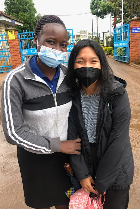 Two women standing on a street in Kenya