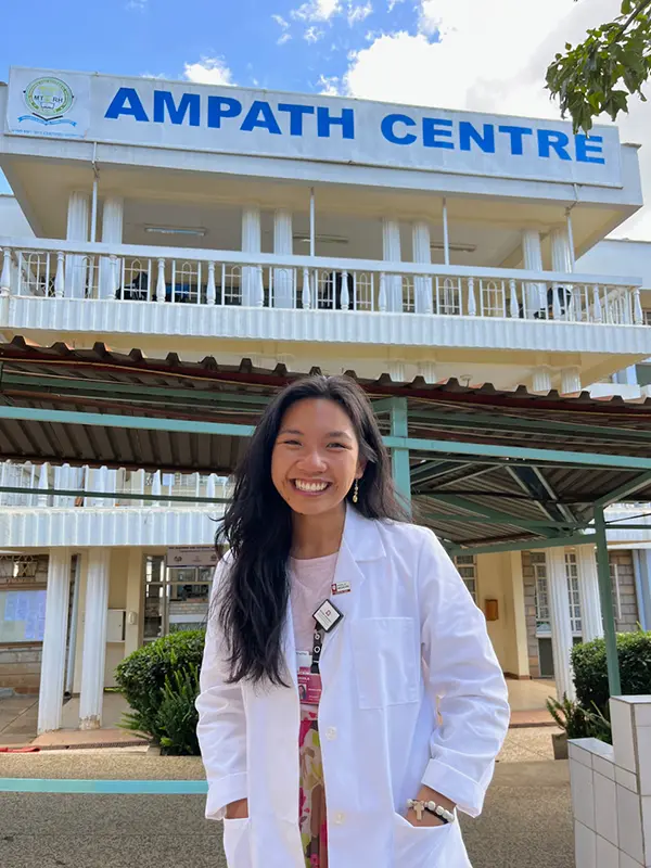 medical student in front of AMPATH Centre in Kenya