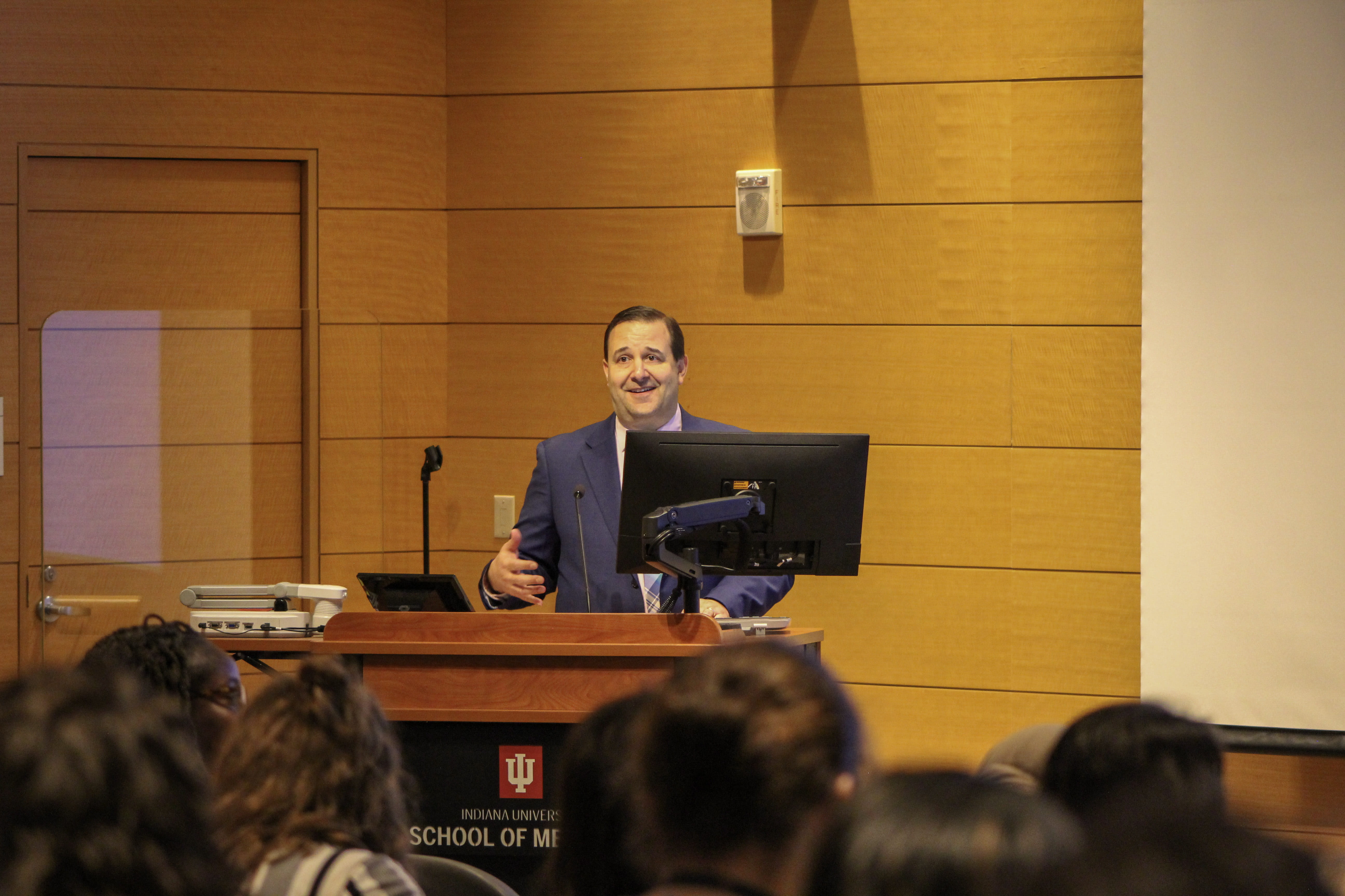 David Haas, MD, MS, the Robert A. Munsick Professor of Obstetrics and Gynecology, stands at a podium while speaking to a crowd during Research Day 2023.