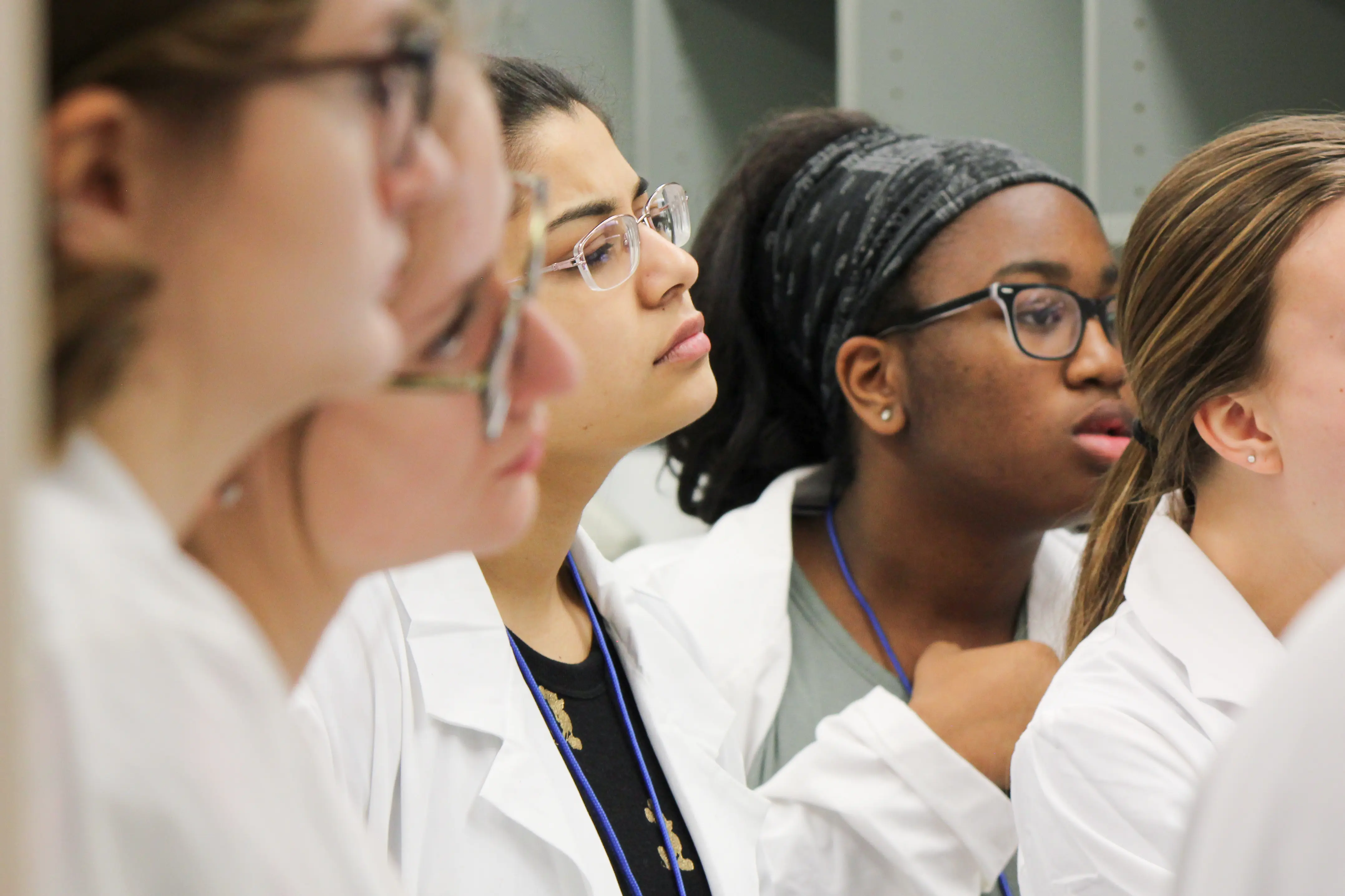 Group of female MMIA students listening to instructions