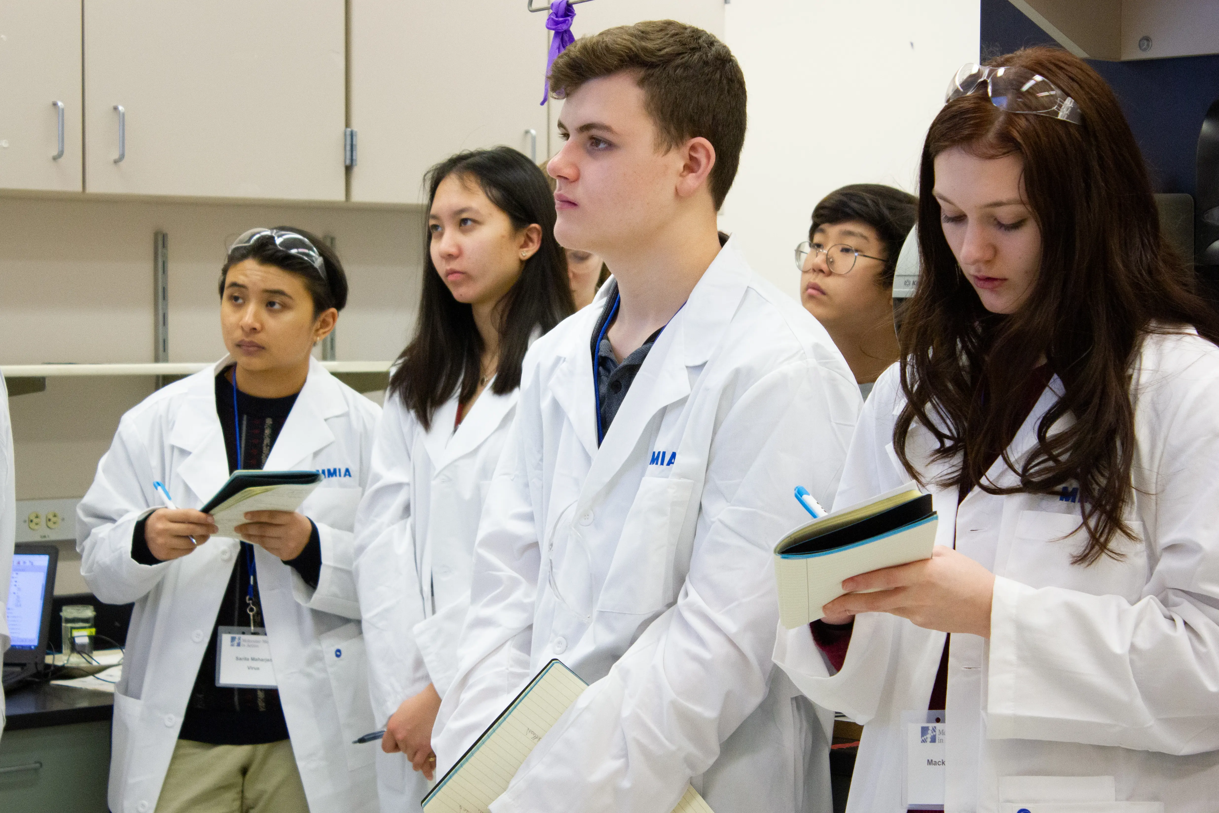 Group of MMIA students listening to instructions
