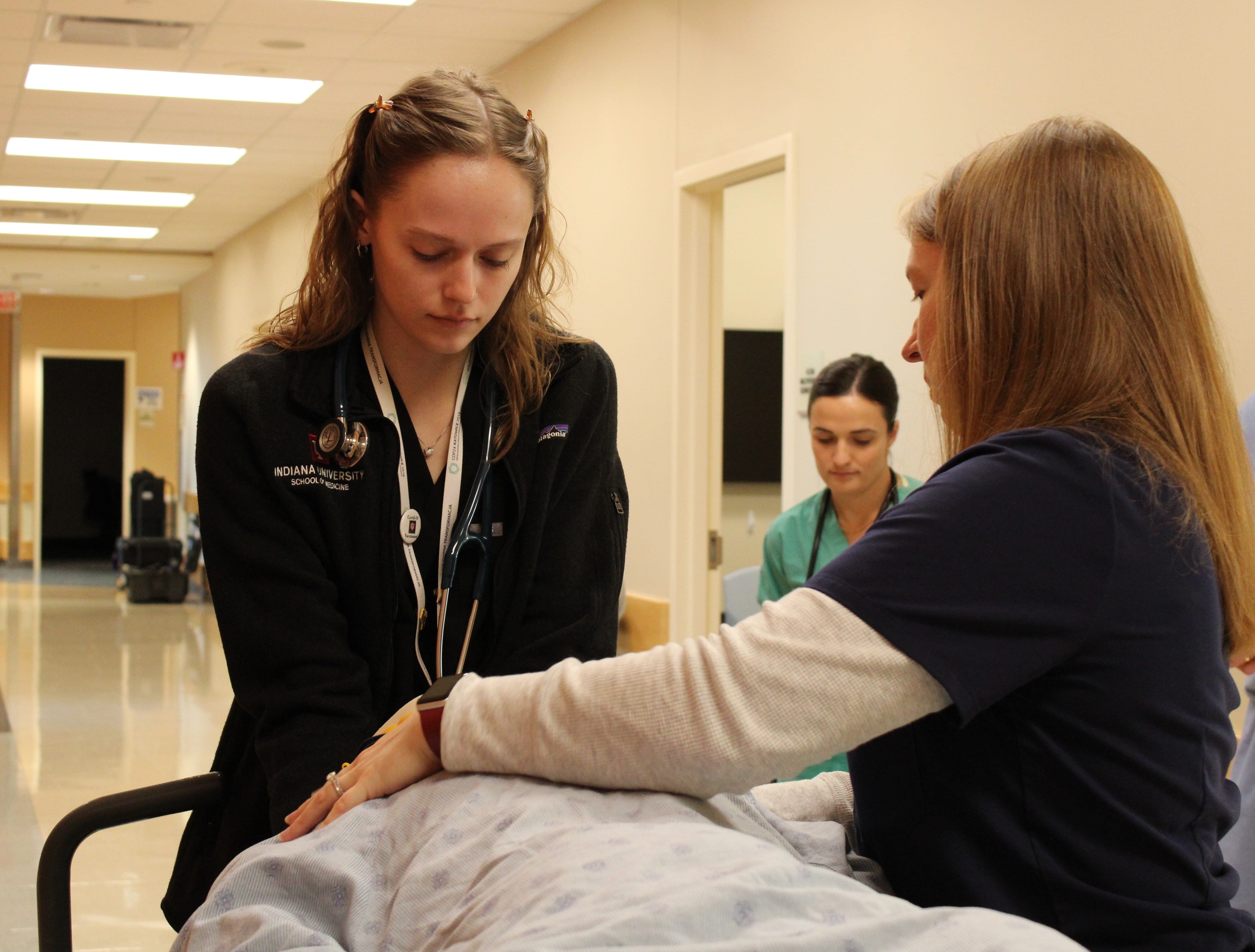 Dr. Rachel Day with a medical student and a simulation patient. 