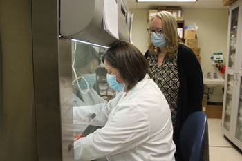 Melissa Kacena, PhD,  stands with a member of her research staff as they work in the lab.