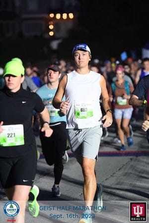 a person running in a group race at night