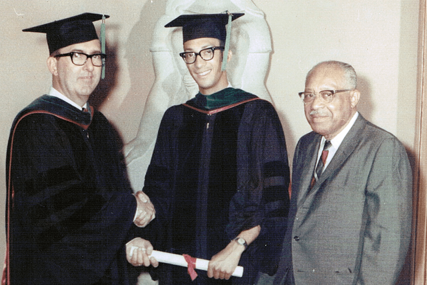 Lester Thompson, MD, flanked by Dean Glenn Irwin, Jr., MD, and Thompson's father, Calvin, at the 1968 IU School of Medicine graduation. Lester Thompson, MD, flanked by Dean Glenn Irwin, Jr., MD, and Thompson's father, Calvin, at the 1968 IU School of Medicine graduation.
