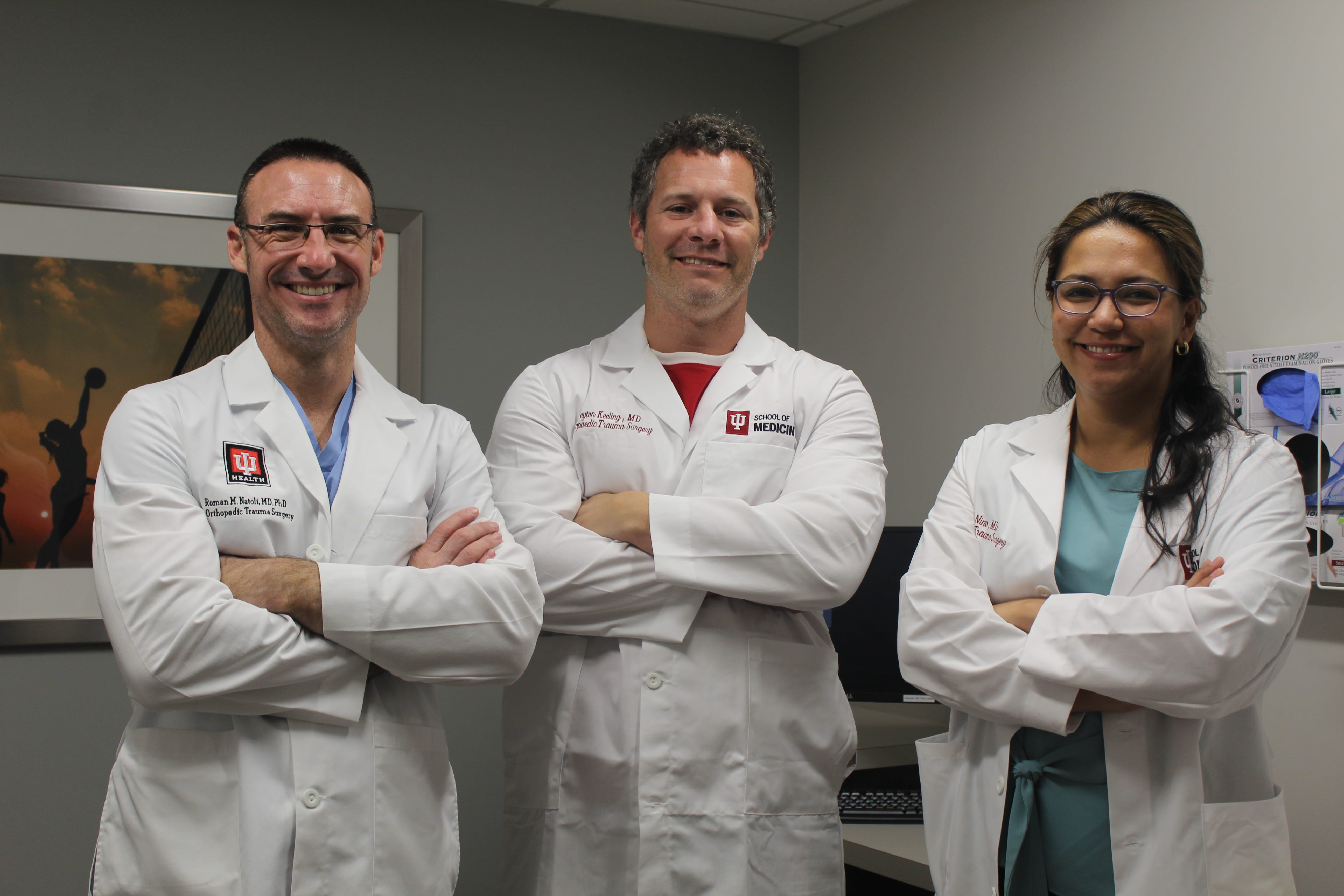 Dr. Roman Natoli standing with two orthopaedic surgery fellows.