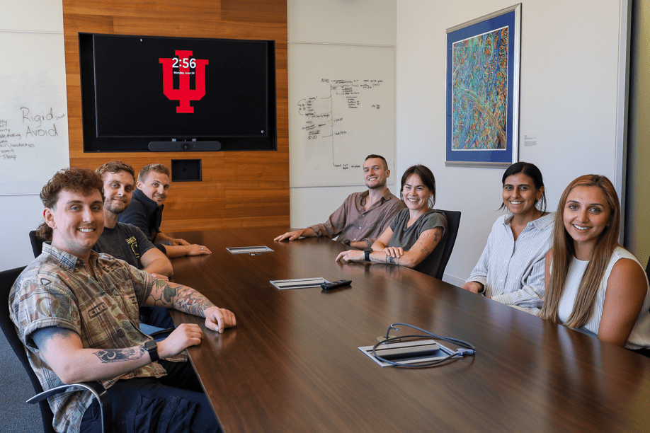 psychiatry residents sit around a confernce table during a meeting