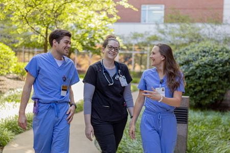 three residents walk outside in muncie
