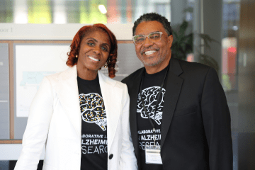 two Black community members wearing matching alzheimer's disease tshirts at an outreach event