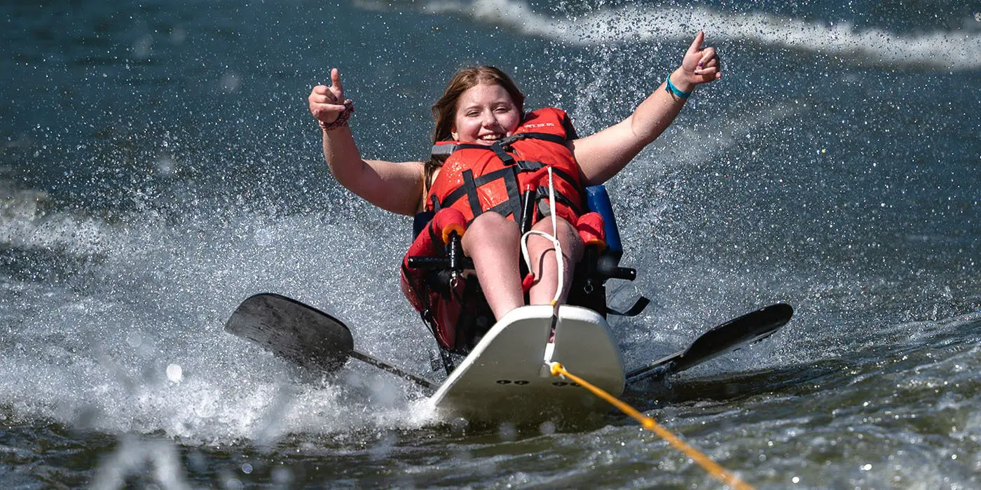 A young woman wake boarding at Camp Riley