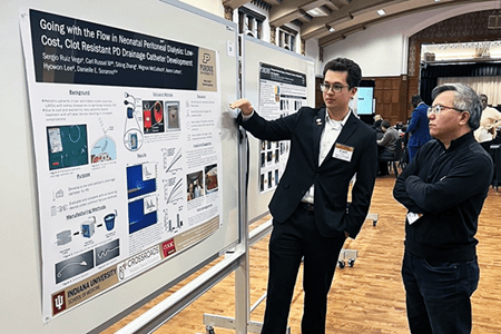 Carl Russell presents his research poster at Education Day.