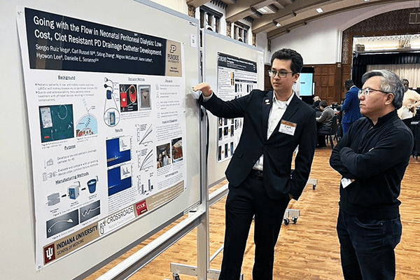 Carl Russell presents his research poster at Education Day.