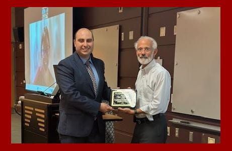 Division Director Michael Econs, MD, presents an award to Wade Jodeh, MD.