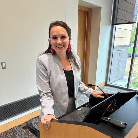 Dr. Emily Fitz smiles before presenting on a topic at a conference.. 