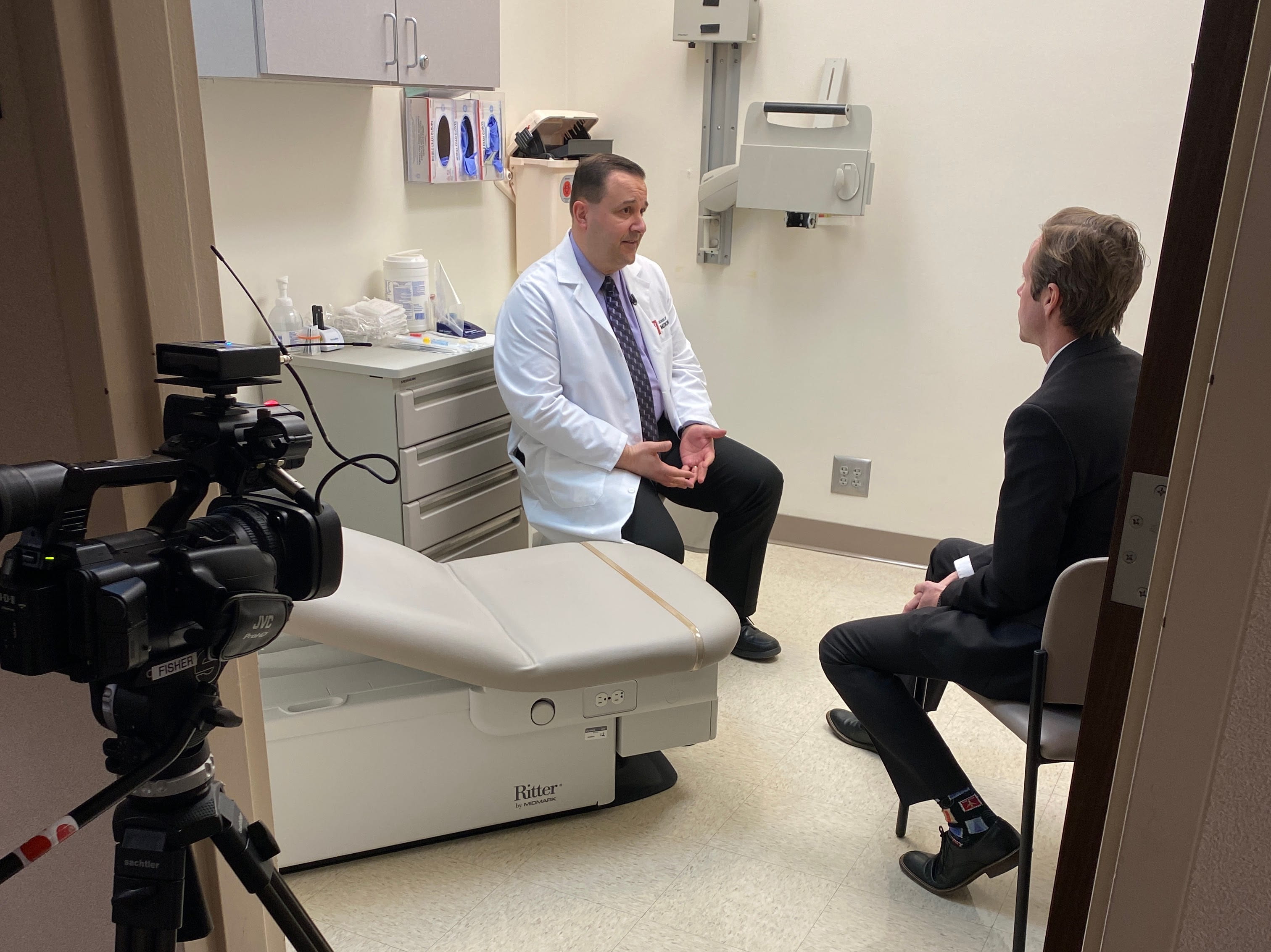 Doctor talking to a reporter in a media interview