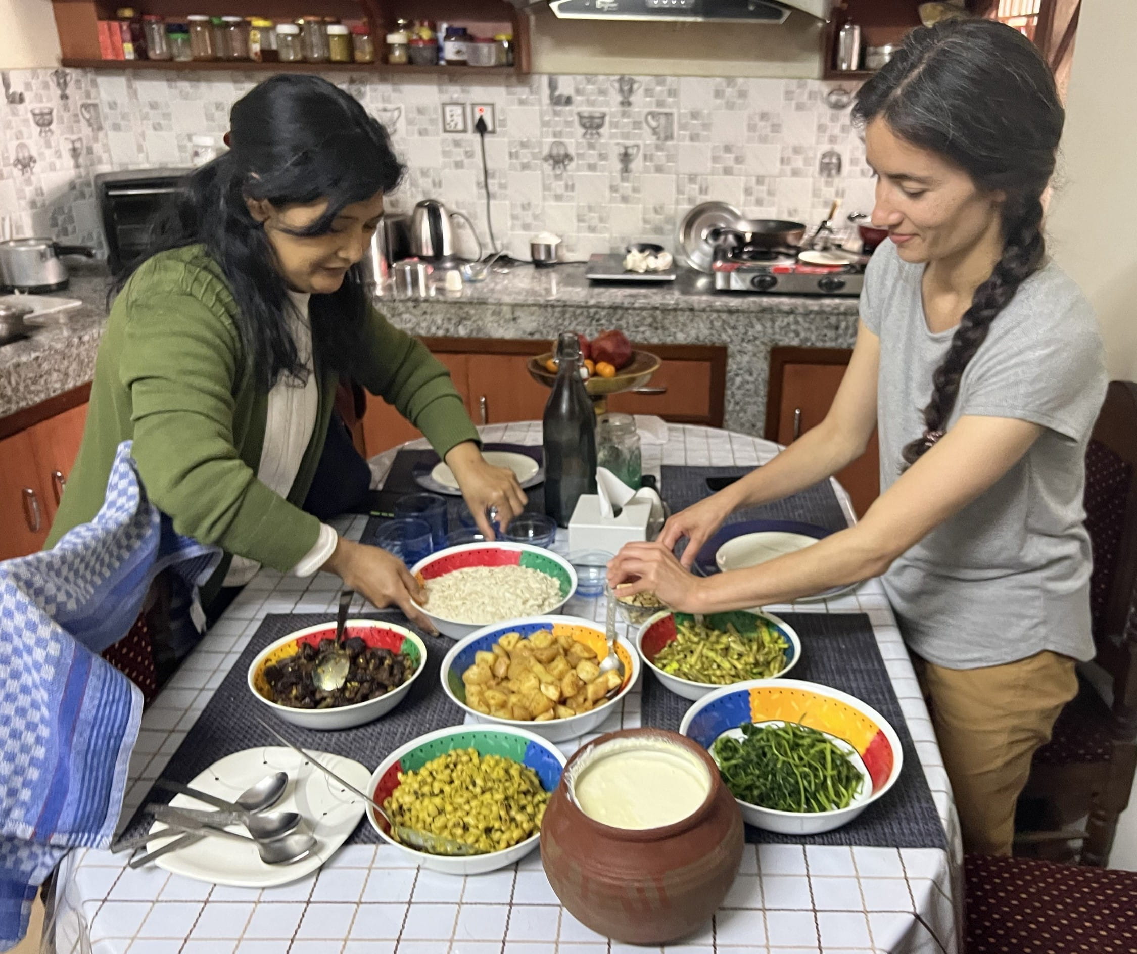 Kate Anderson, MD enjoys a meal with a friend in Nepal.