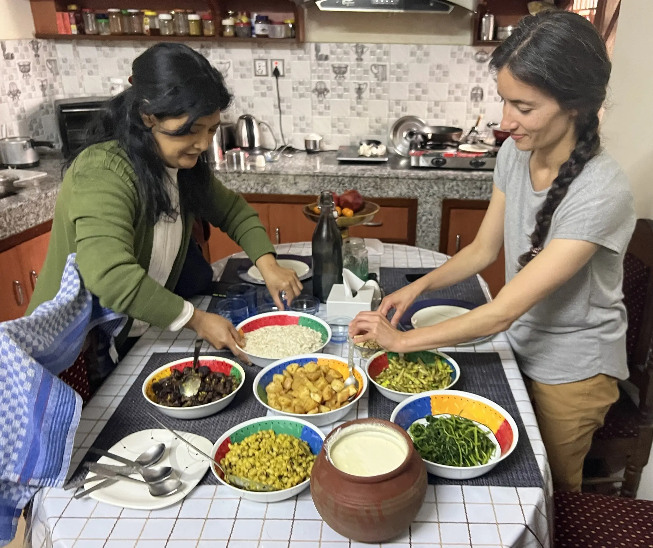 Kate Anderson, MD enjoys a meal with a friend in Nepal. 