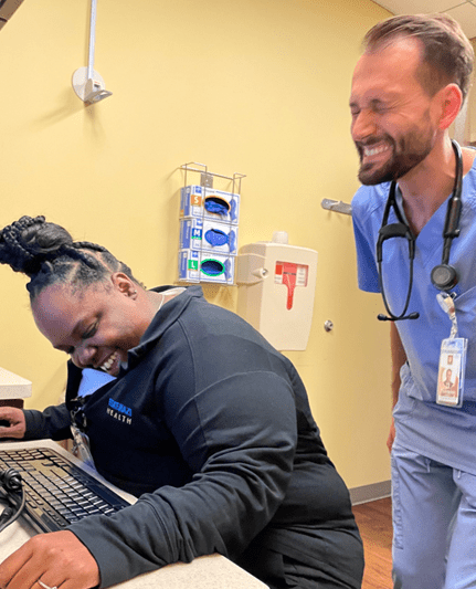 resident and nurse laughing