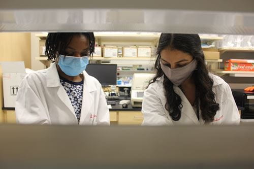 Olatundun Awosanya works in the Kacena Lab with another researcher