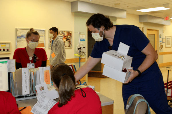 Johnny Krasinkiewicz delivers a box of donuts to a nursing unit at Riley Hospital