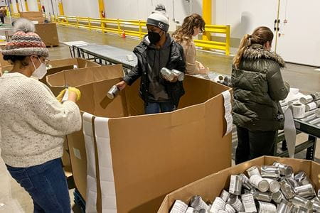 Staffers from the Department of Orthopaedic Surgery sort cans at Gleaners Food Bank