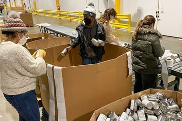 Staffers from the Department of Orthopaedic Surgery sort cans at Gleaners Food Bank