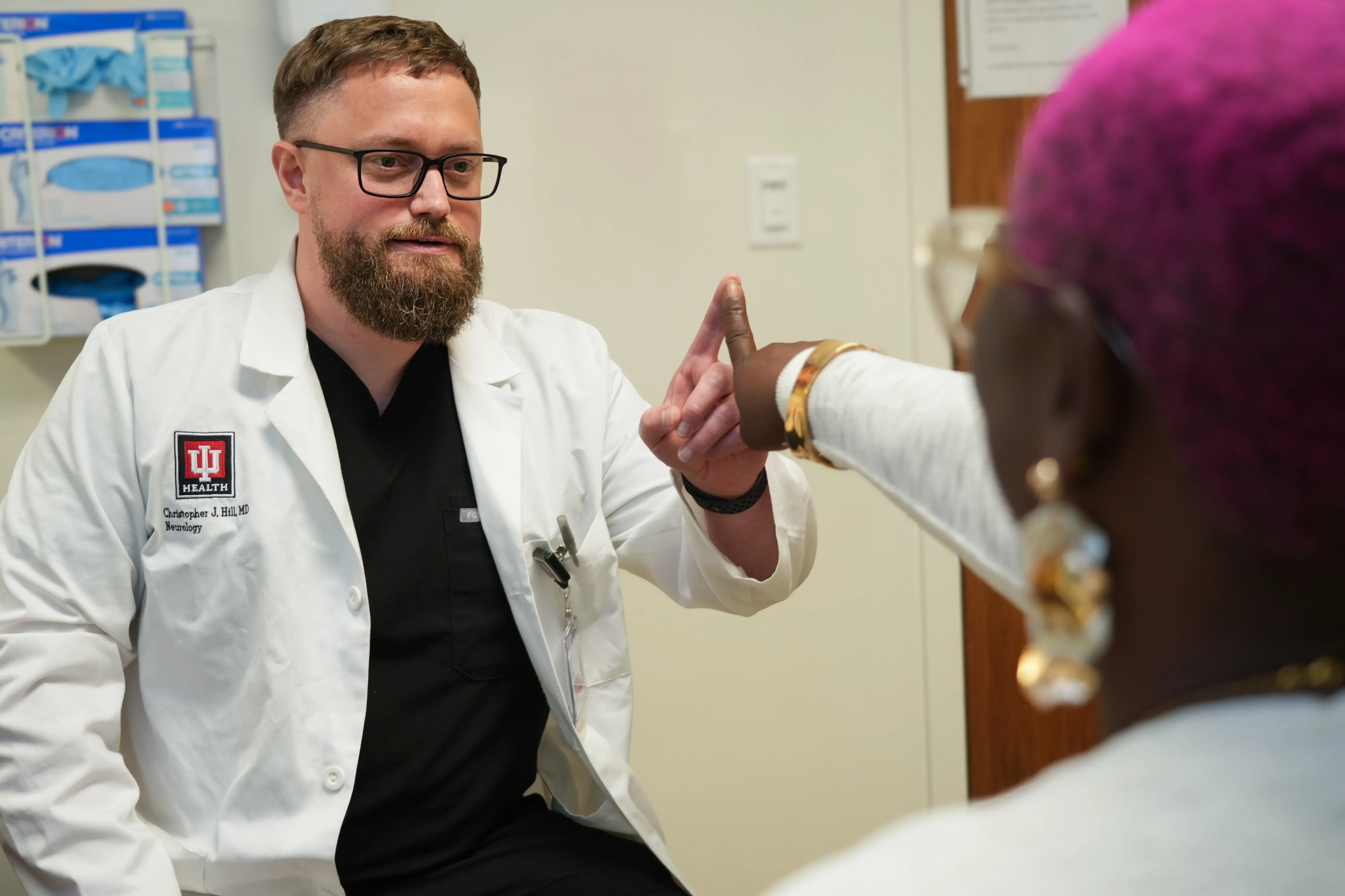 Dr. Christopher Hill examining a patient in the clinic