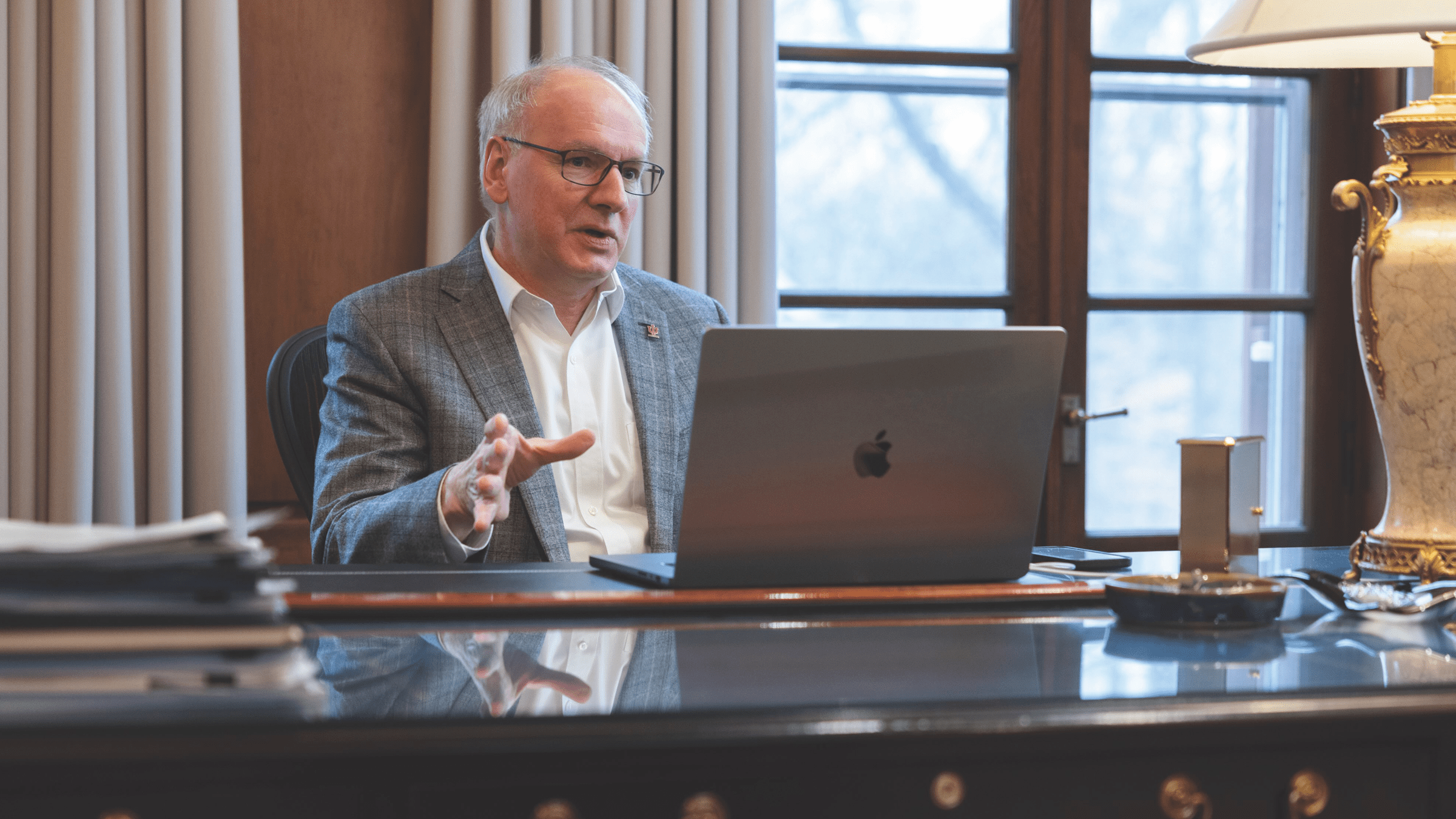 Dean Jay Hess speaking with laptop in front