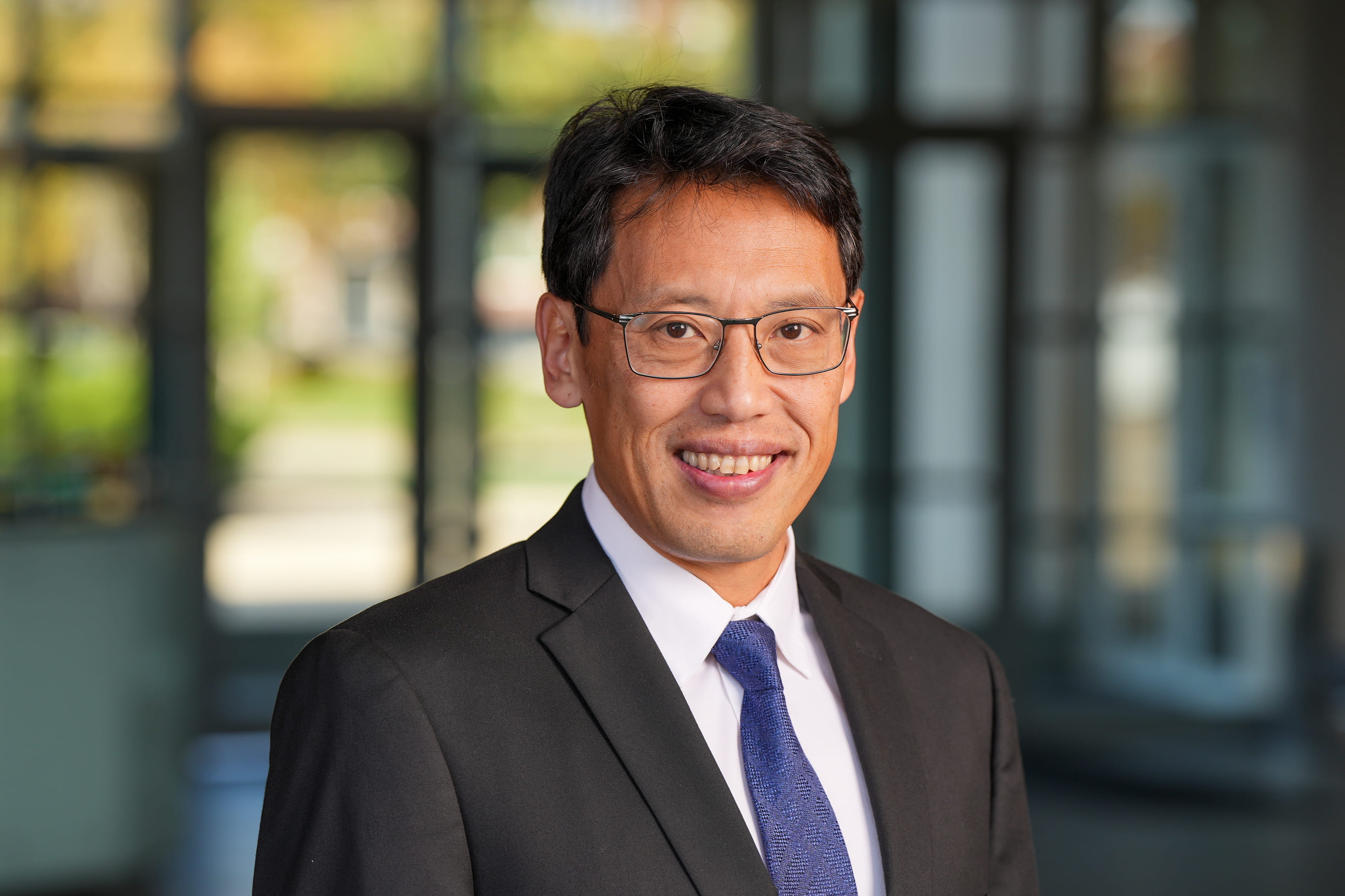 A man poses for a headshot photo