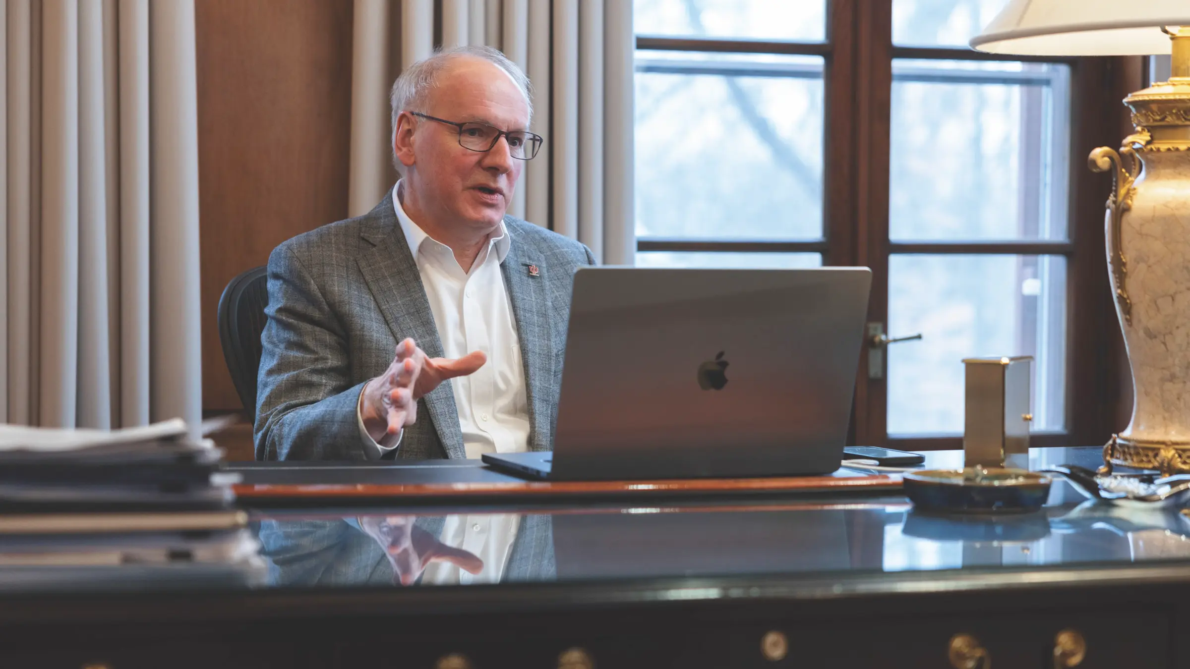 Dean Jay Hess speaking with laptop in front