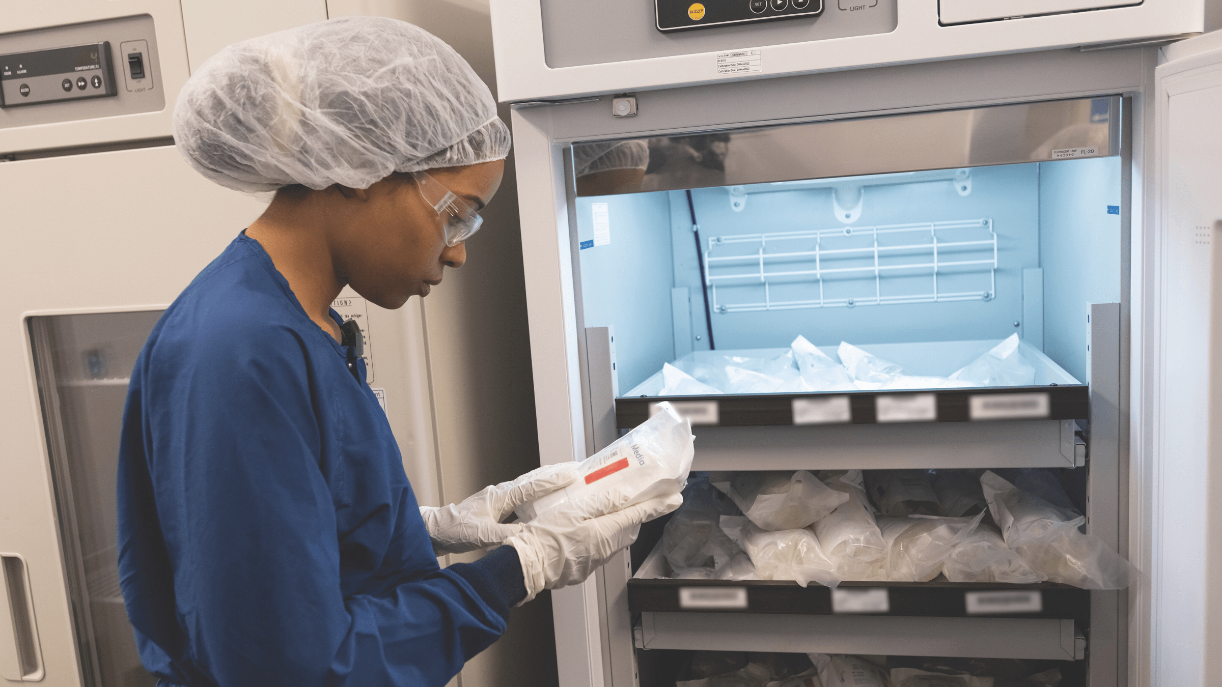 A person standing with a bag in their hand