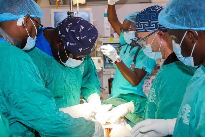 Jason Axt, MD, AMPATH’s surgery in-country leader, operates alongside Kenyan colleagues at Moi Teaching and Referral Hospital in Eldoret, Kenya, providing complex pediatric surgical care while mentoring local surgeons in the operating room.