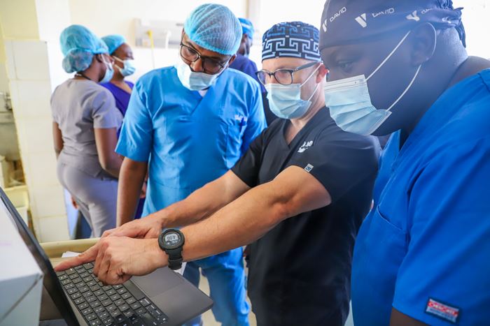 Jason Axt, MD, consults with surgical trainees and faculty at Moi Teaching and Referral Hospital in Eldoret, Kenya, helping build sustainable surgical training programs through AMPATH’s partnership model.