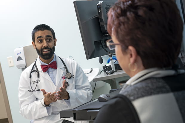 Physician in an office speaking with a patient