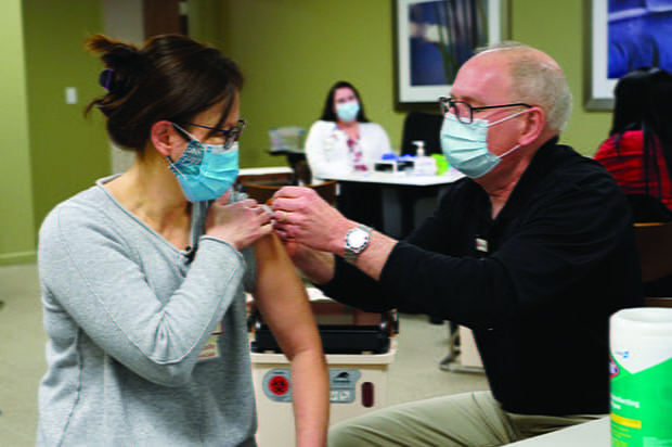 Jay Hess giving a patient a shot