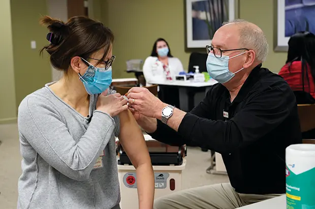 Jay Hess giving a patient a shot