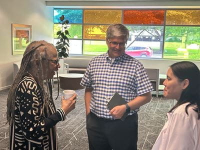 Crystal Shipp, Jeff Dage and Sophia Wang speaking during a break at a IU symposium