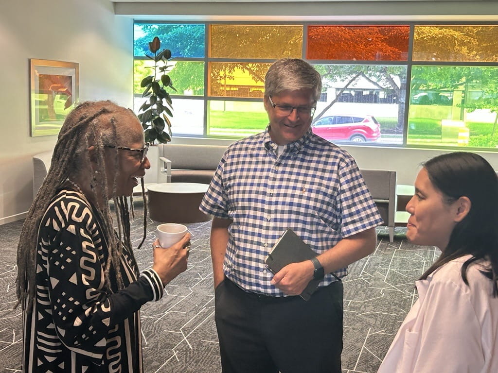 Crystal Shipp, Jeff Dage and Sophia Wang speaking during a break at a IU symposium