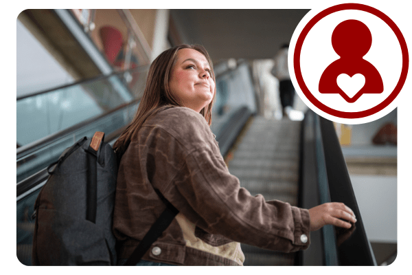 A young woman rides an escalator