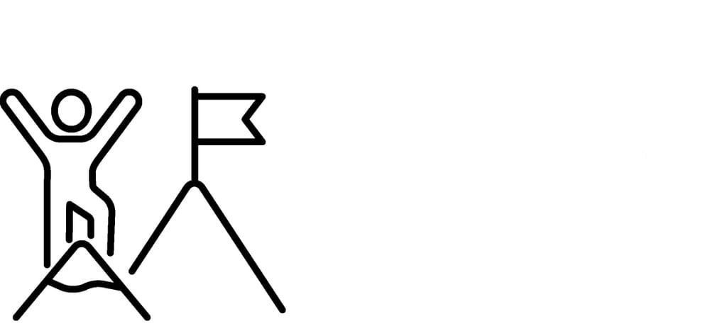 a person stands on a mountain summit