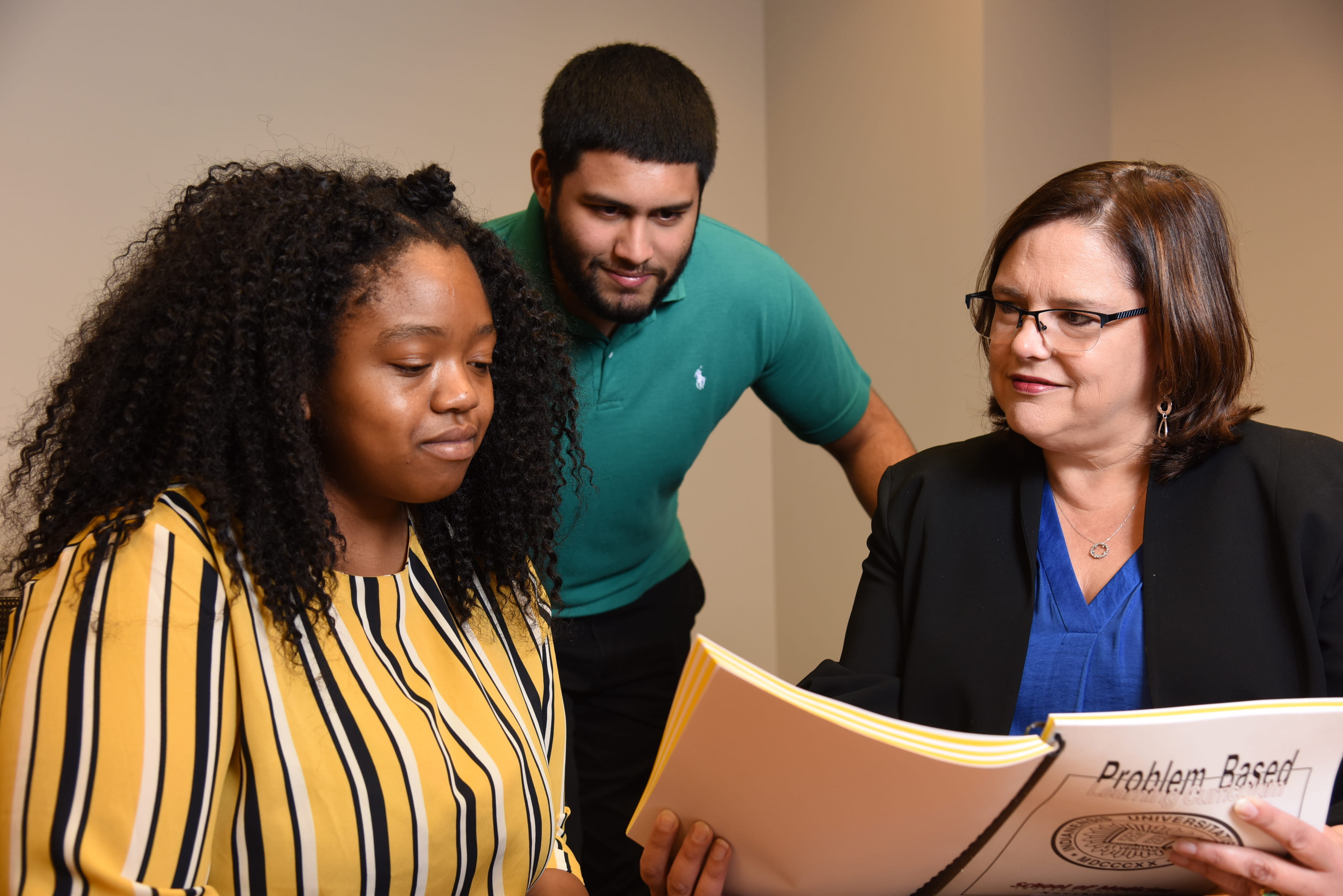 students and advisor review course materials together
