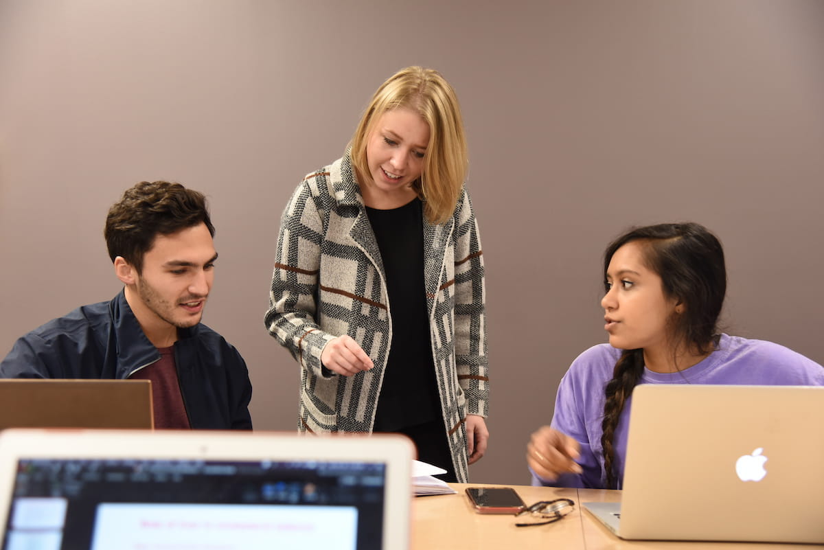 a faculty member teaches students in a small classroom in evansville