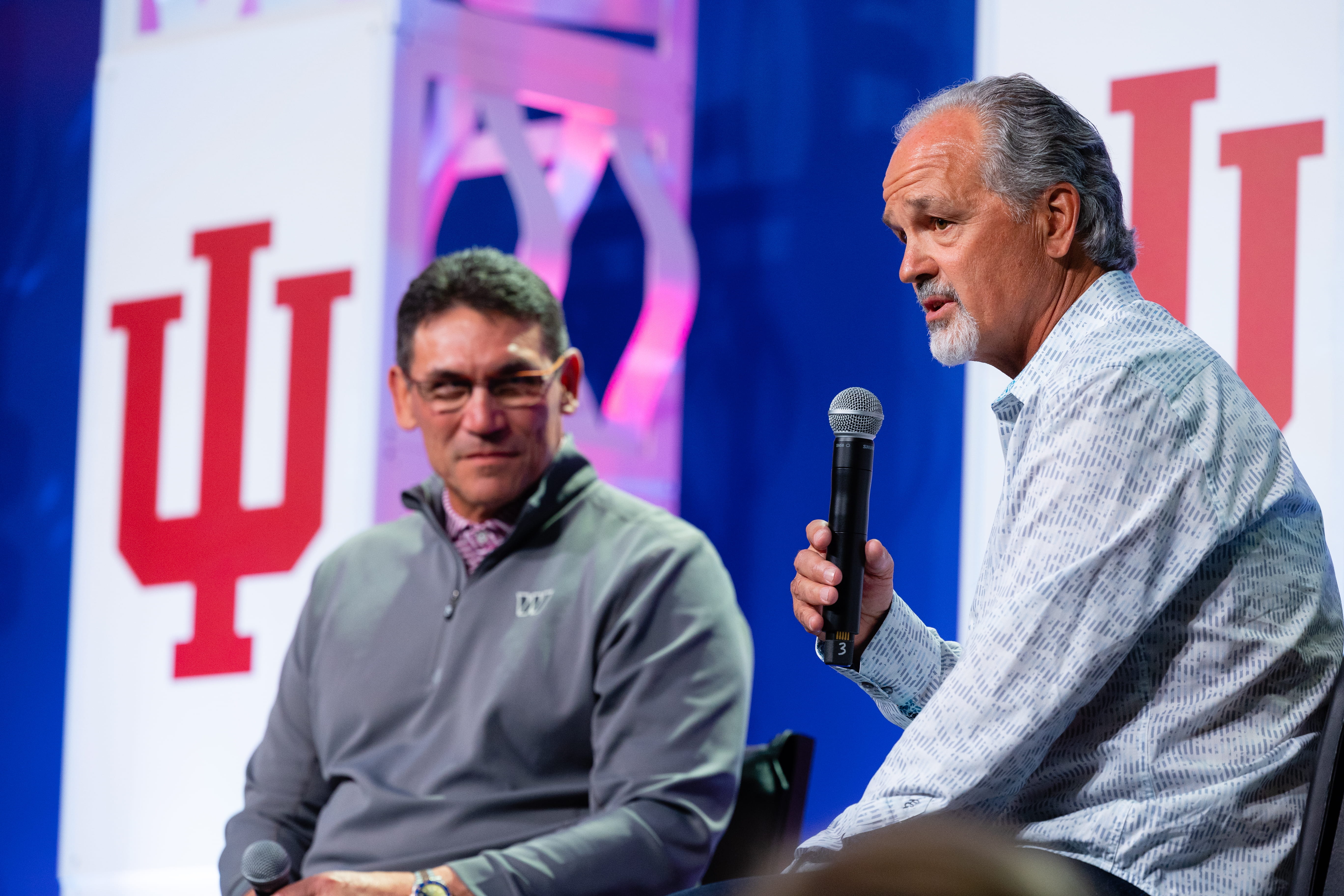 chuck pagano holds a microphone onstage at the chuckstrong gala