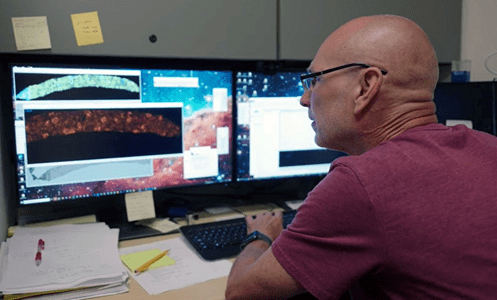 Michael Ferkowicz, PhD, MS, examines images of human kidney cells.