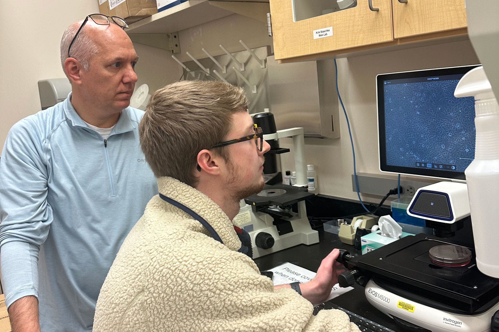 Kirk Staschke and Noah Sommers at the microscope